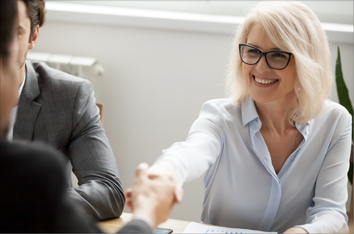 Business woman shaking hands with a client