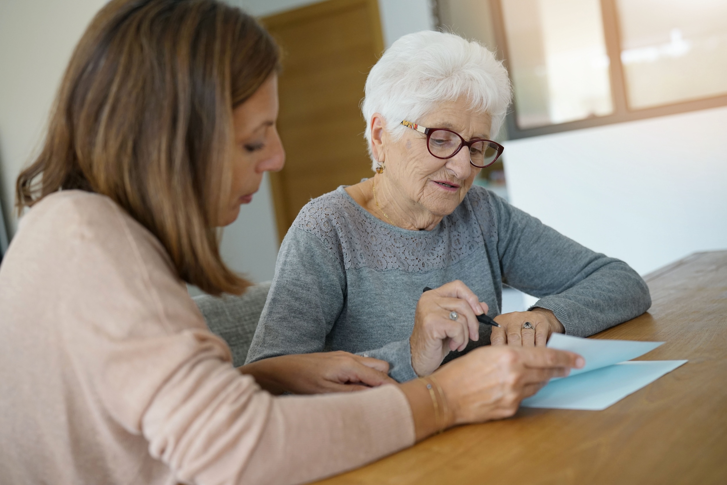 A senior advisor from Owl Be There, a senior care franchise for placing seniors into assisted living, working with a client.