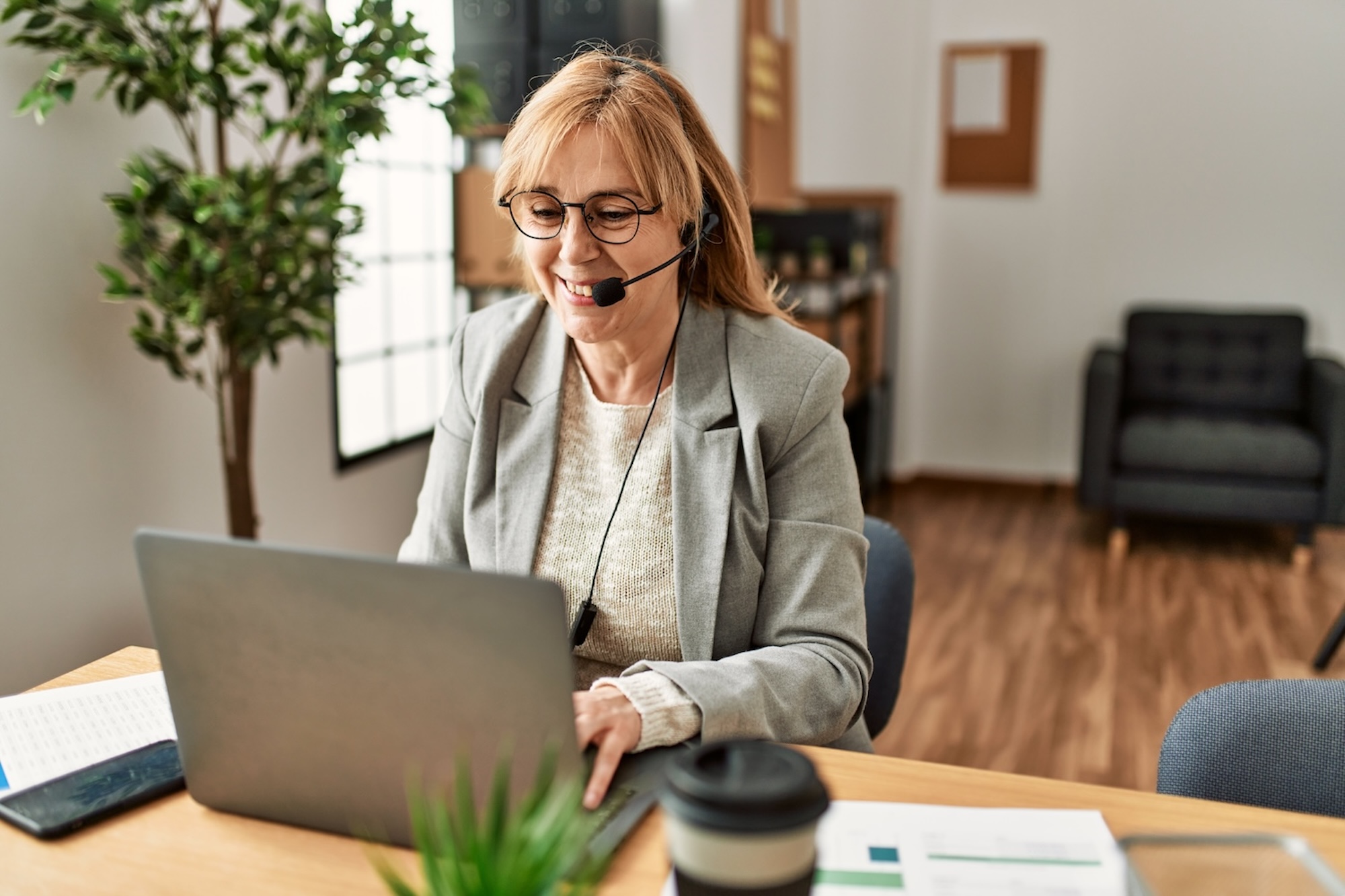 woman working as a senior care franchise advisor in her home office.