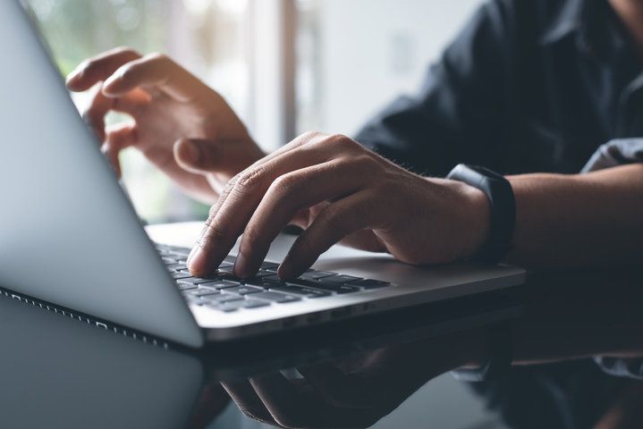 Hands typing on computer. 