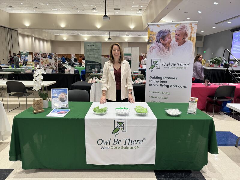 LuAnn Martinson, an Owl Be There Senior Living Advisor, working an Owl Be There Booth at an expo.